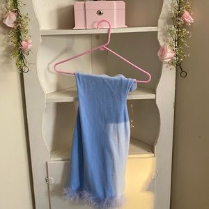 Strapless pastel blue dress with feathers at the bottom